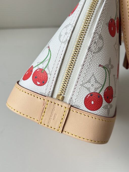 LV x TM Alma BB. Authentic quality luxury bag crafted in genuine leather comes with authenticity card, dust bag and gift bag. A Joyful Icon Reimagined. Playful, artistic, and instantly iconic—the Alma BB returns in a joyful re-edition as part of the celebrated LV x Murakami collection. This petite masterpiece blends the timeless Art Deco-inspired silhouette with Takashi Murakami’s signature whimsy, splashing the House’s Monogram canvas with bold, cherry-bright motifs. Crafted with natural leather accents and finished with polished gold-tone hardware, it features structured Toron top handles and a charming bow-shaped keybell that adds just the right amount of flirt. Compact yet attention-commanding, the Alma BB is a true collectible—full of joy, color, and unmistakable LV heritage. Carry art. Wear happiness. Make a statement.