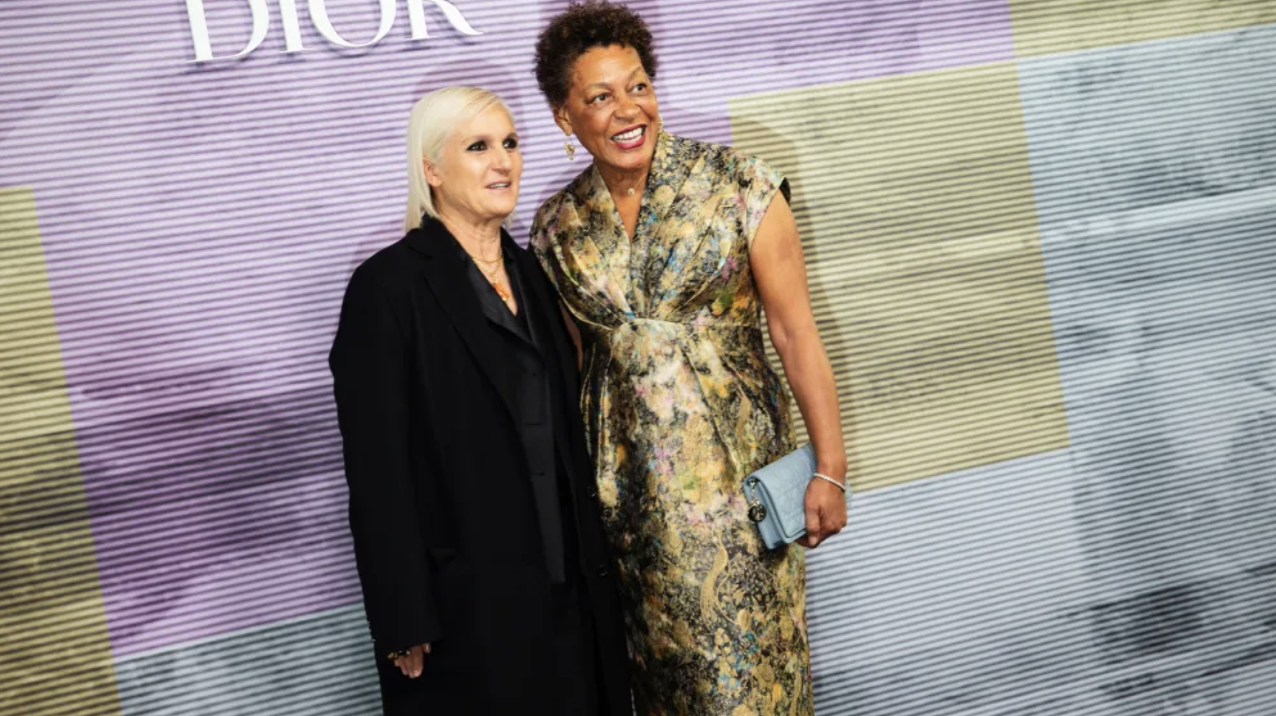 At a Dior event, two women stand together, their fashion choices symbolizing strength, solidarity, and empowerment. At a Dior event, two women stand together, their fashion choices symbolizing strength, solidarity, and empowerment.