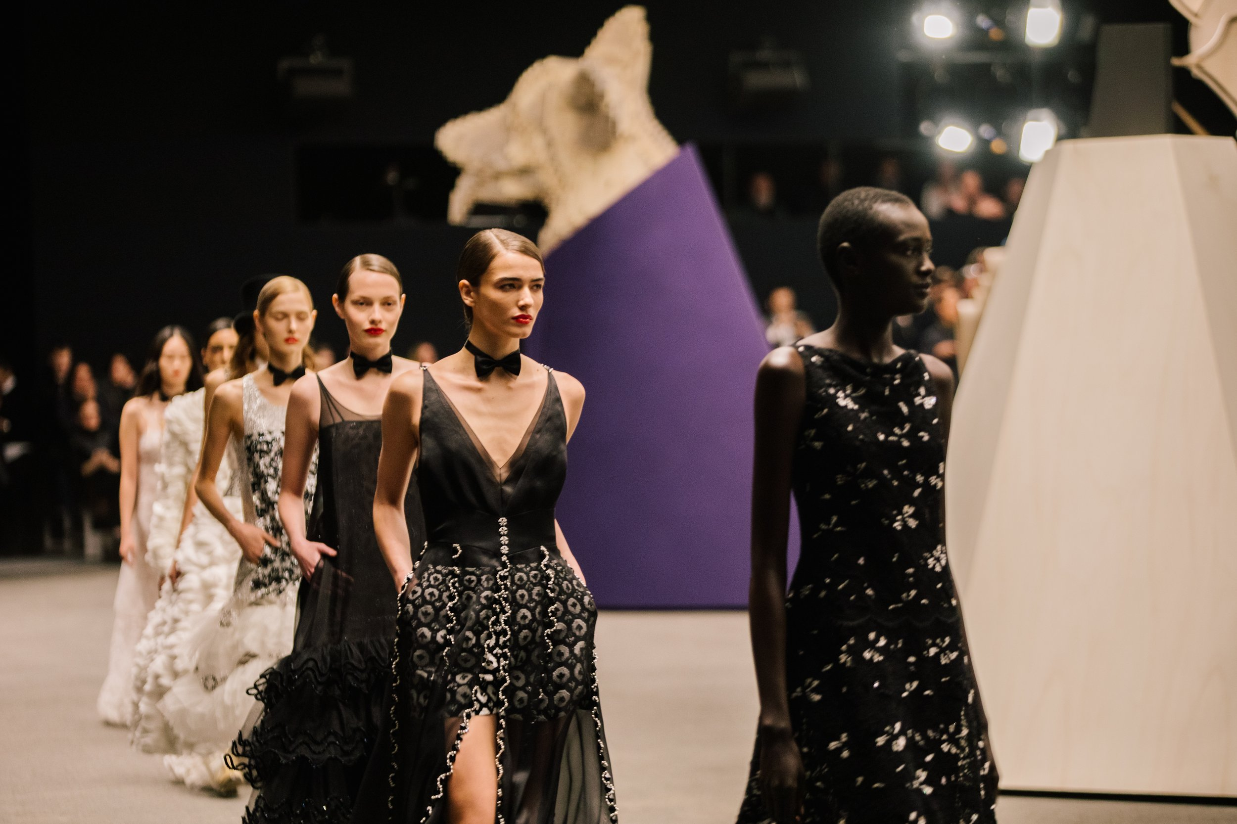 A noir-tinted tribute to elegance: eveningwear infused with texture, movement, and couture precision—where every step tells a story in black and white. A noir-tinted tribute to elegance